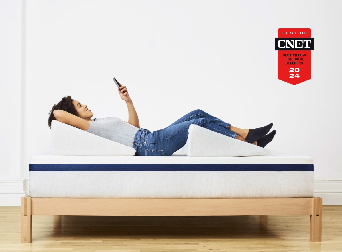 Woman using two Helix Wedge Pillows on a Midnight Core mattress.