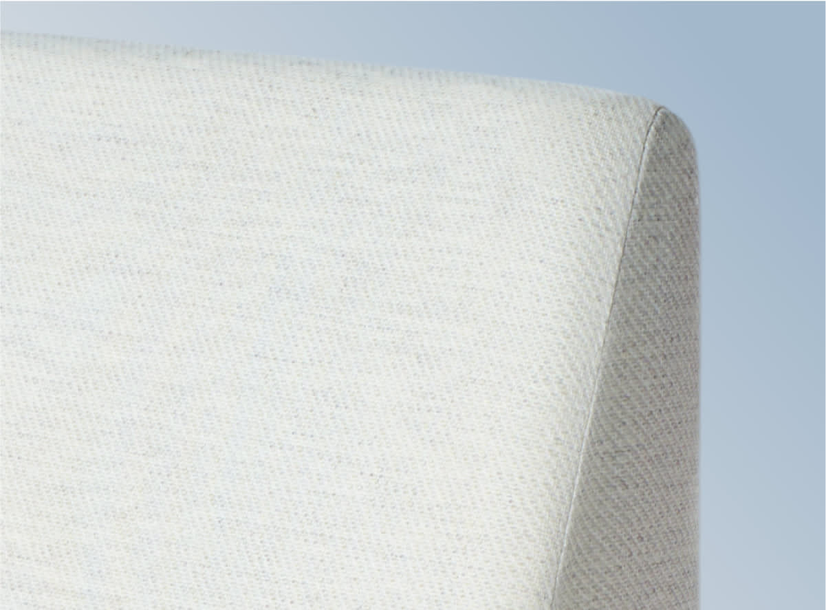 The Helix Wedge Pillow on a blue gradient background