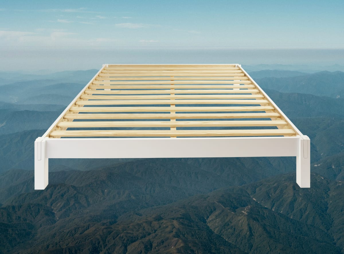 A product image of the Madison Bed Frame on a mountain scene background