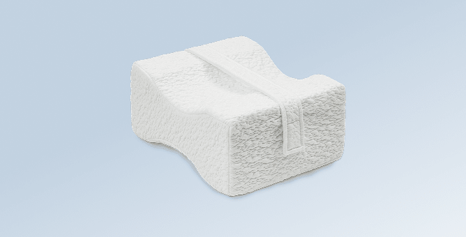 The Knee pillow on a light blue gradient background