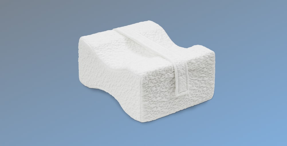 The Side Sleeper Knee Pillow on a gradient blue background