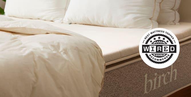 A rendered image of the Plush Organic Mattress Topper showing its awards and accolades