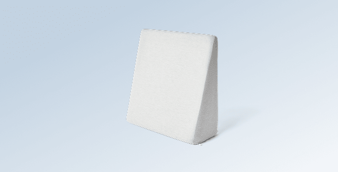 The Wedge pillow on a light blue gradient background