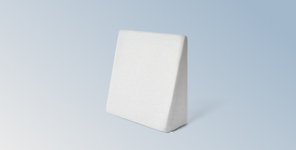The Wedge Pillow on a gradient blue background
