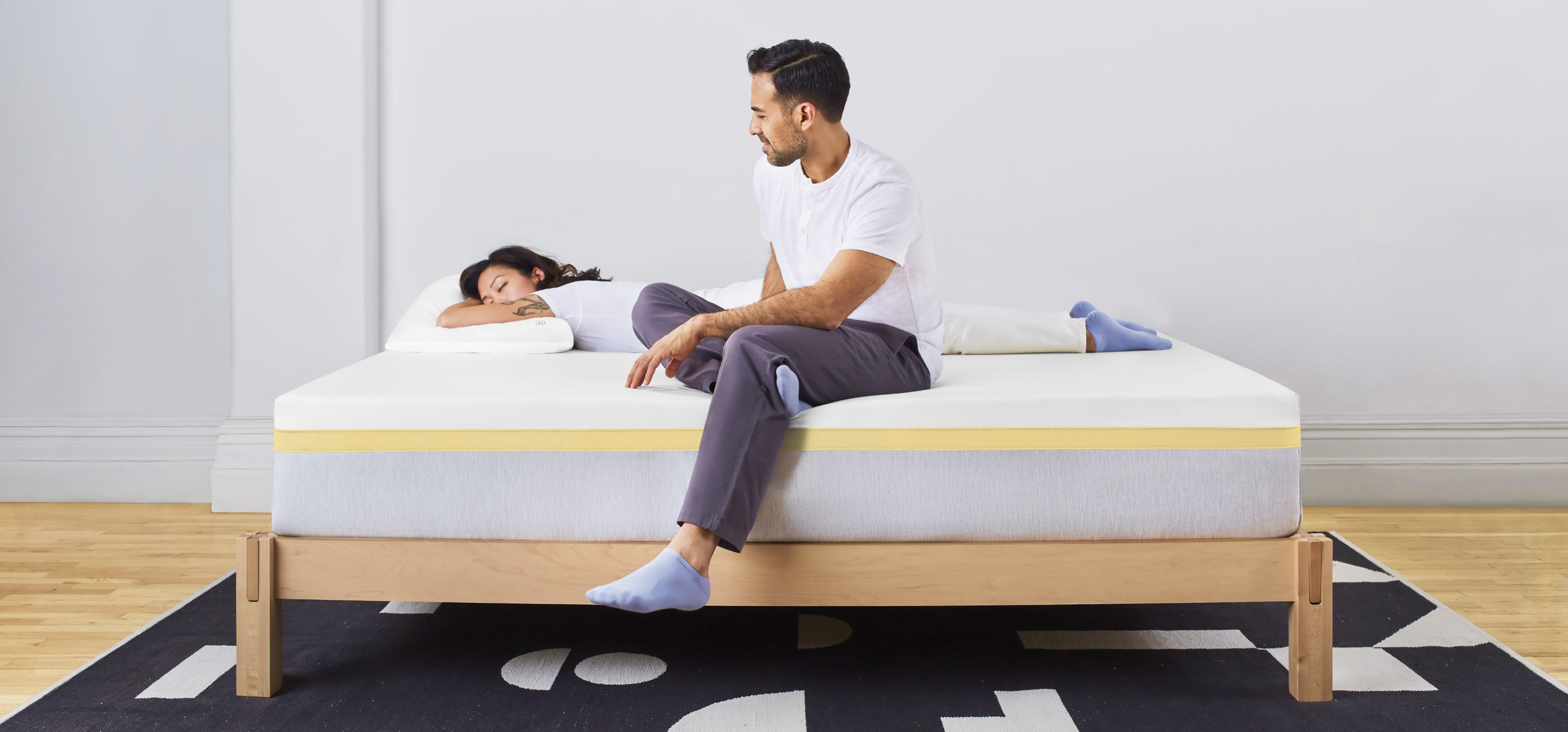 Woman and man laying in Helix Dawn Mattress