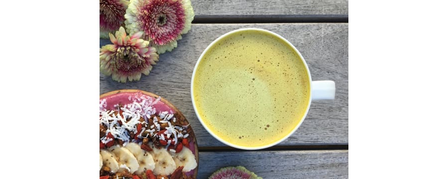 Golden Milk latte with flowers and an acai bowl