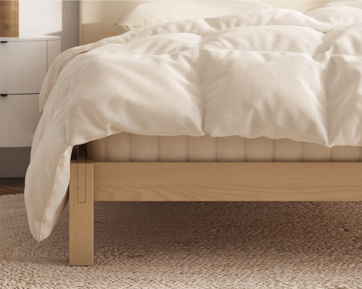 A closeup mage of the Natural Down Duvet Insert laid across a bed