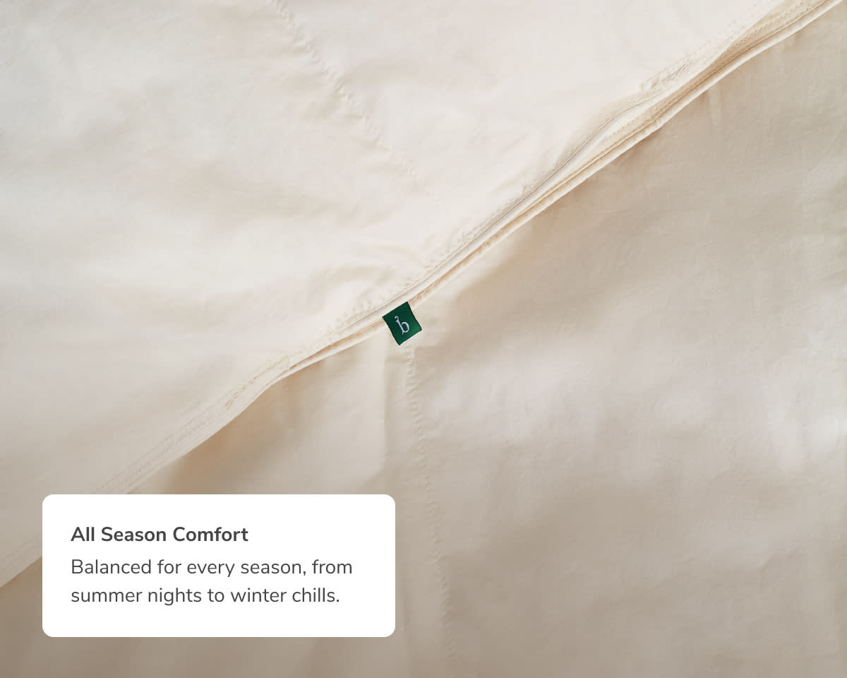 A closeup mage of the Natural Down Duvet Insert with a callout to its all season comfort