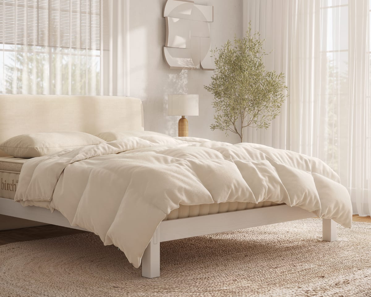 An image of the Natural Down Duvet Insert laid across a bed in a bedroom scene