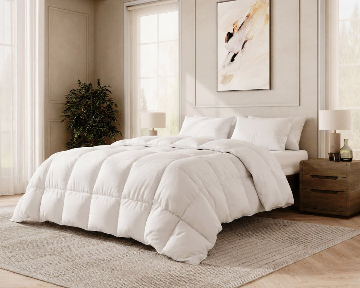 An image of the Down Alternative Duvet Insert laid across a bed in a bedroom scene