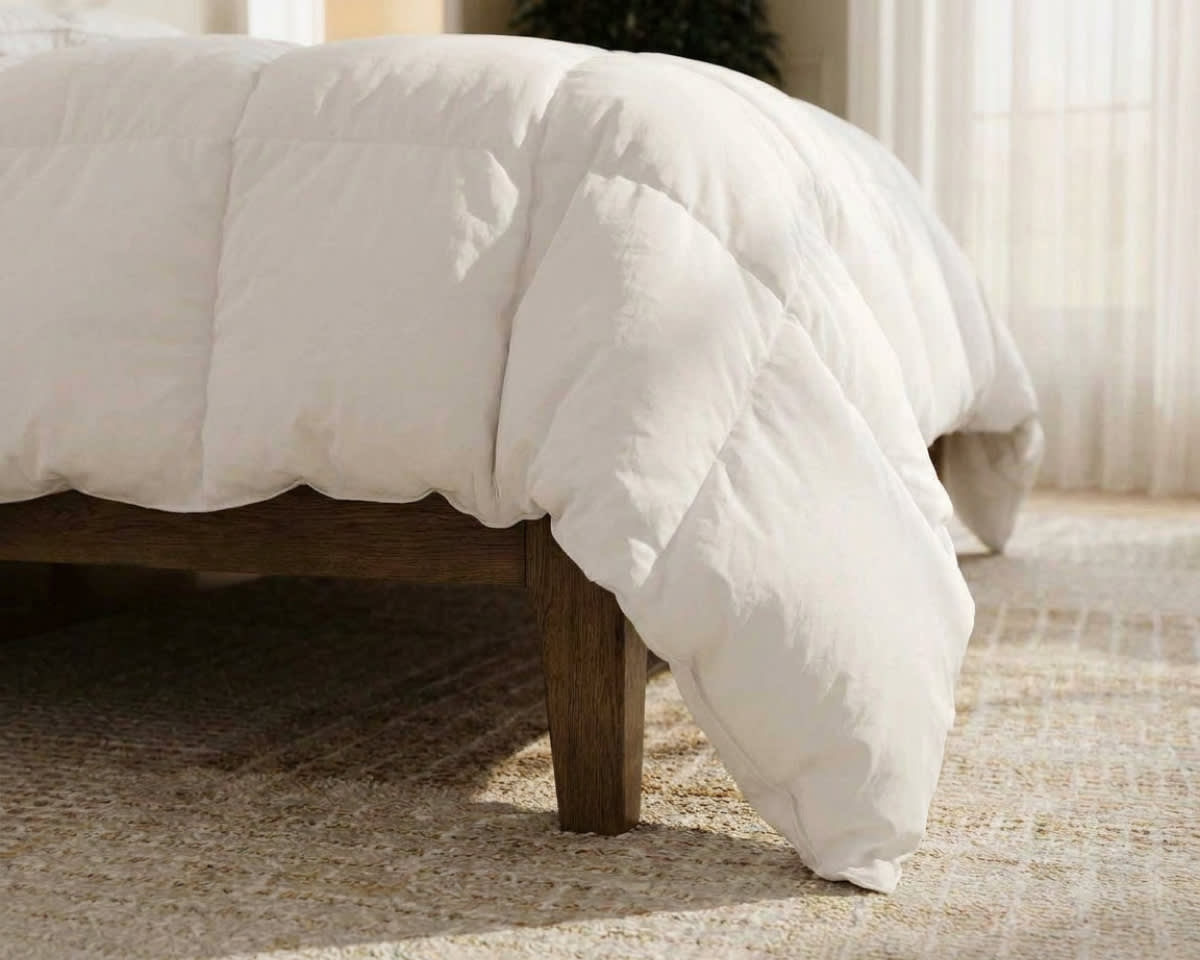 An image of the Down Alternative Duvet Insert laid across a bed in a bedroom scene