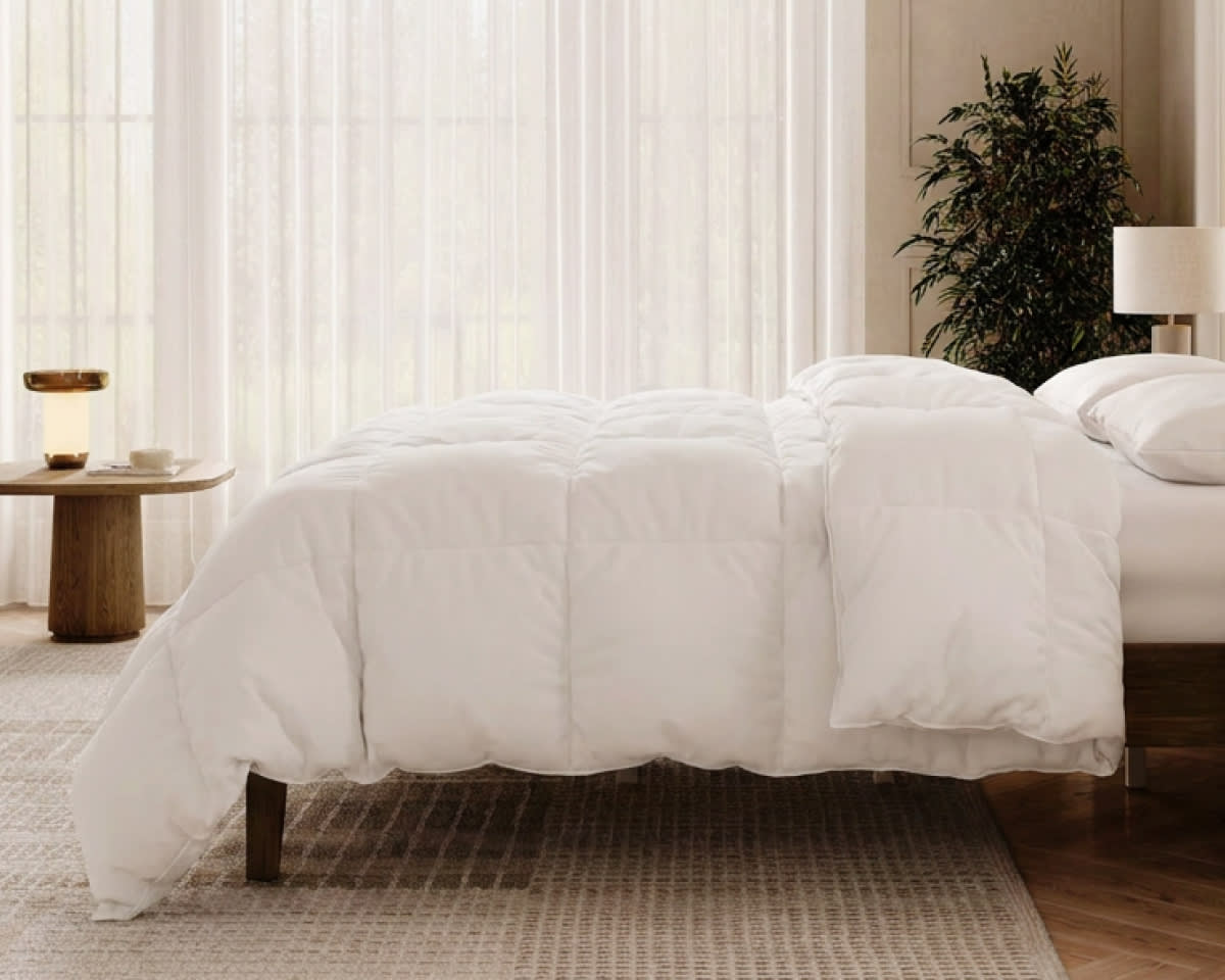 An image of the Down Alternative Duvet Insert laid across a bed in a bedroom scene