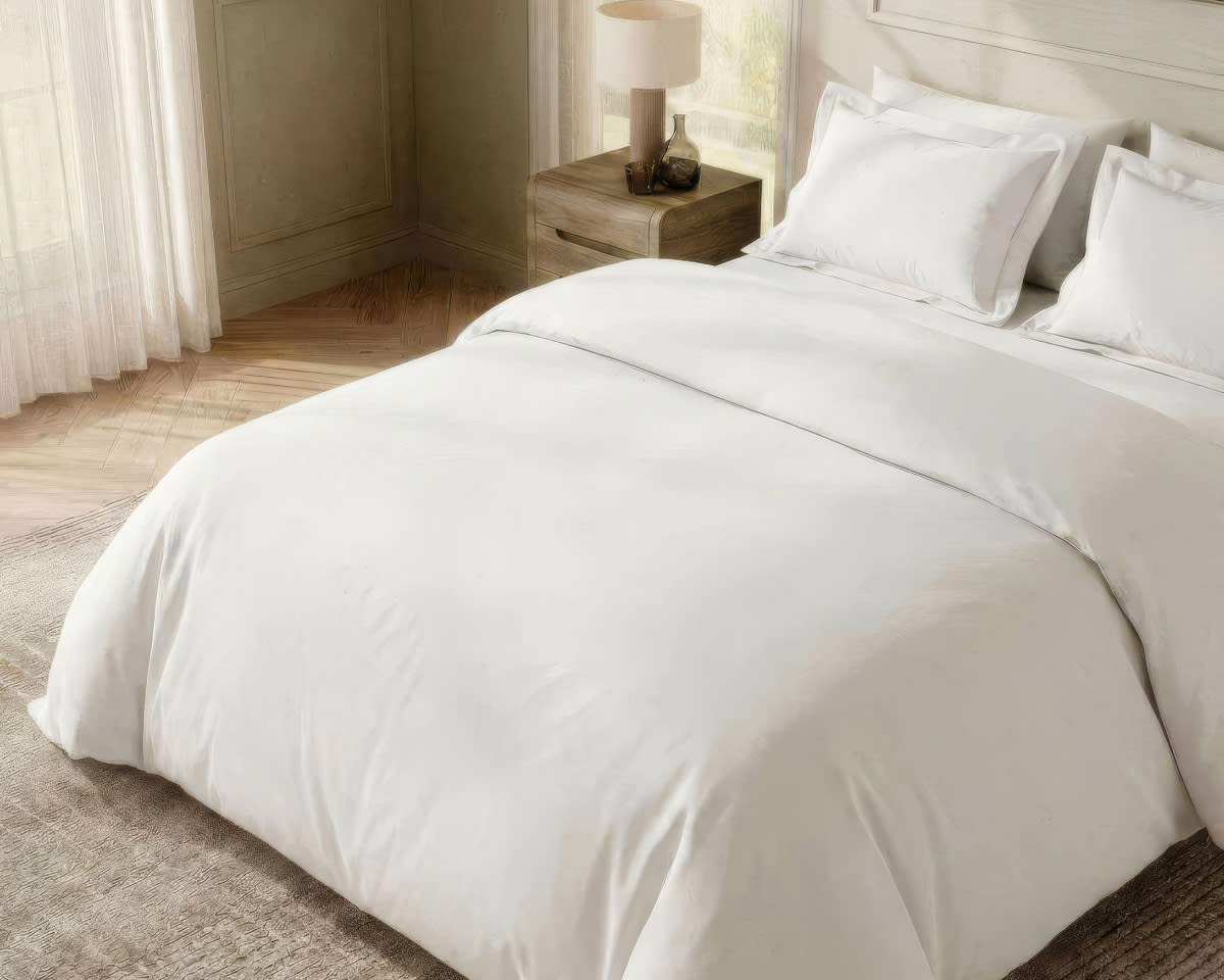 An image of the Duvet Cover and Duvet Insert laid across a bed in a bedroom scene
