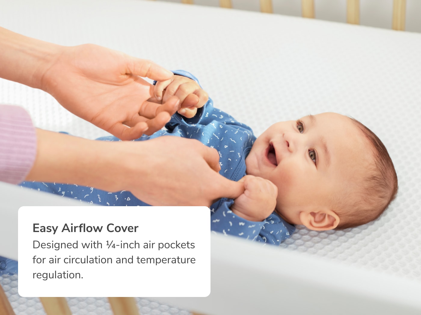 An image of a child on the Helix Crib Mattress with a callout to the Easy Airflow Cover for air circulation