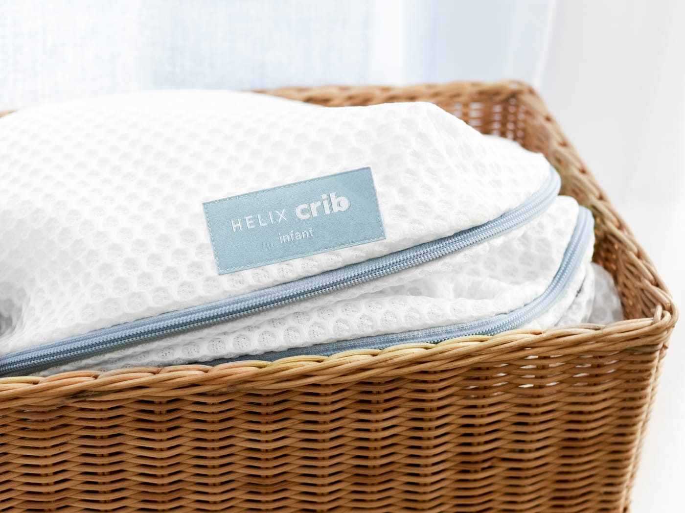 An image of the Crib Mattress Cover in a basket