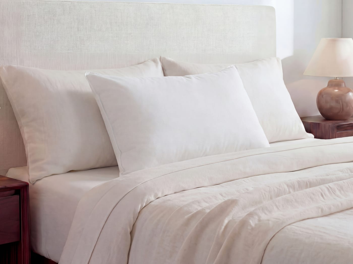 A closeup of the Down and Feather pillow on a bed