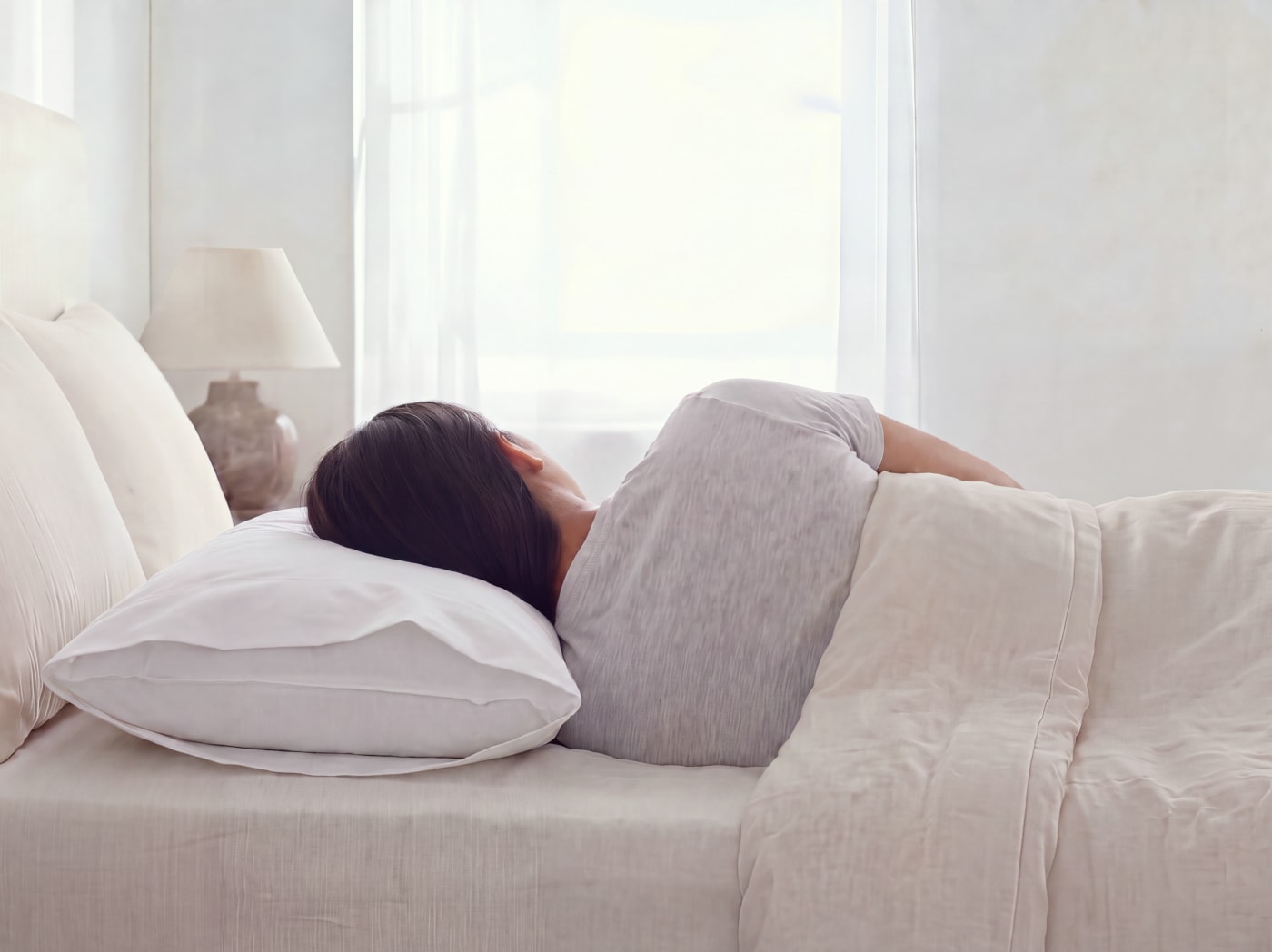 A woman sleeping on a Down and Feather pillow