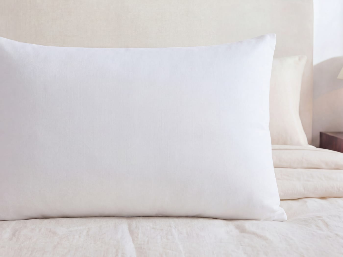 A close up of the Dream Pillow on a bed