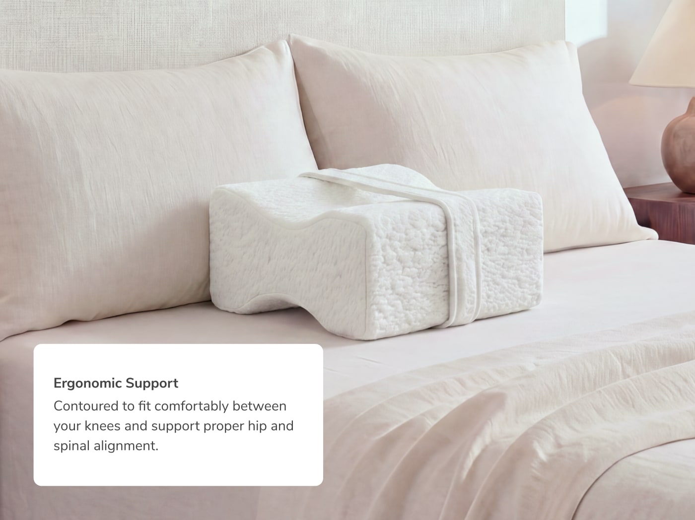 An image of the Side Sleeper Knee Pillow with a callout to its ergonomic support