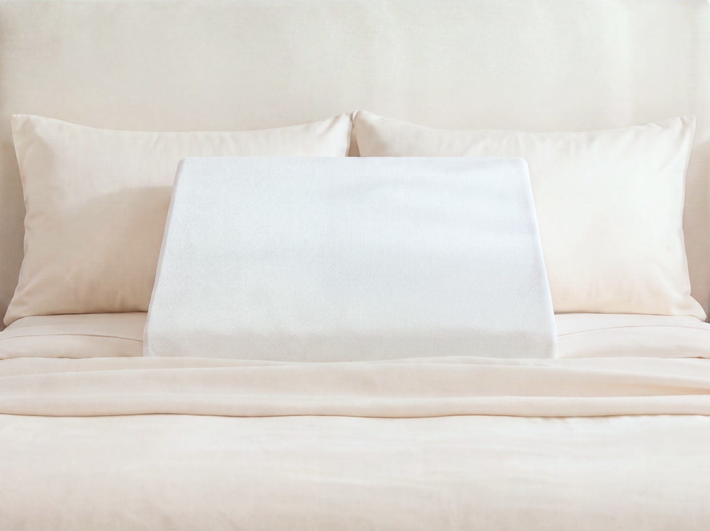 An image of the Wedge Pillow on a bed