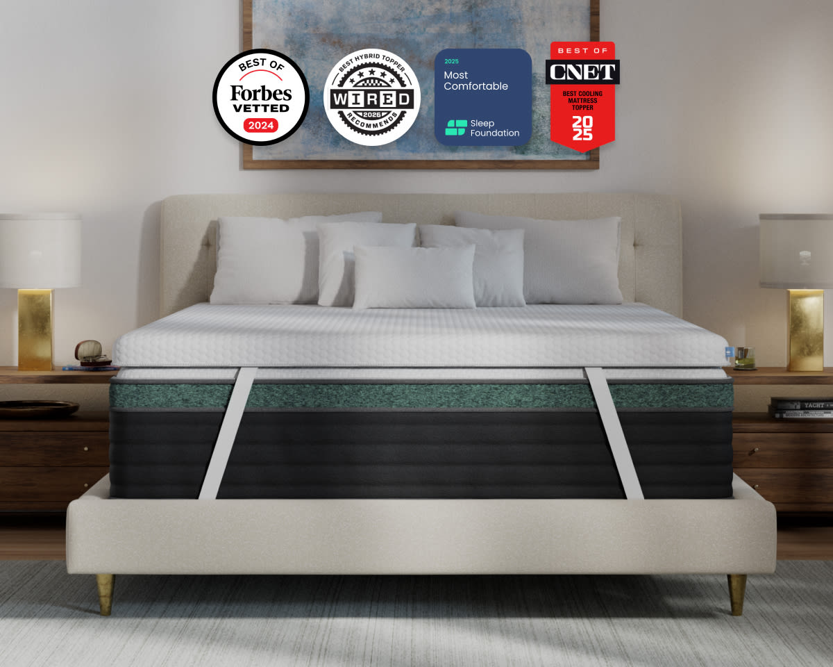 A rendered image of the Premium Mattress Topper with in a bedroom scene with 4 badges showcasing its awards