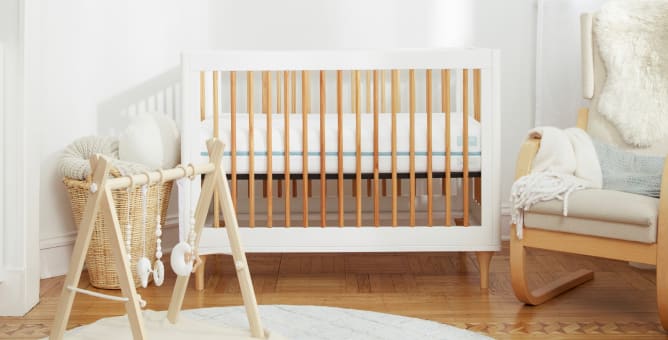 A rendered image of the Helix Crib mattress in a bedroom scene
