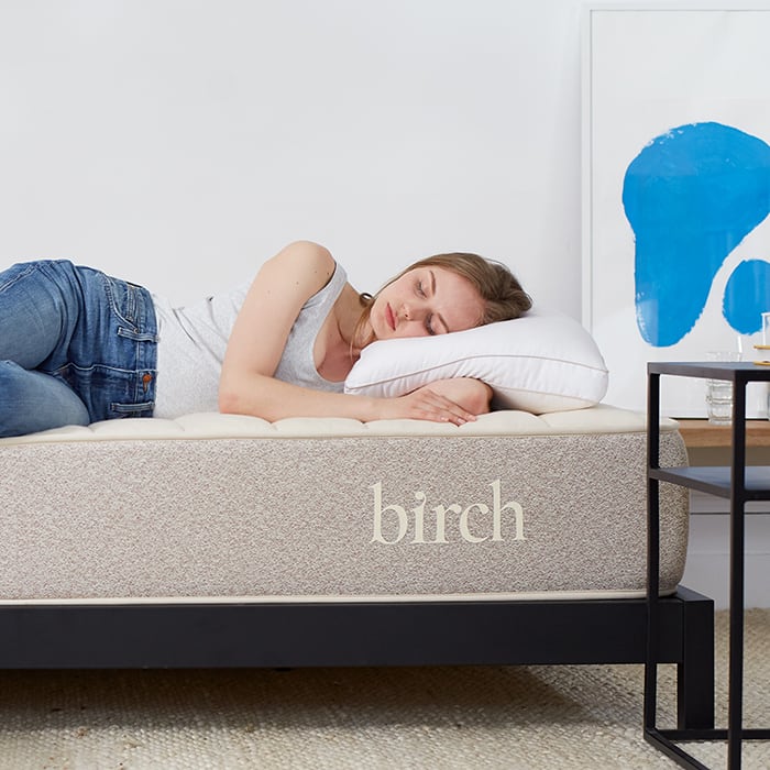 Woman laying on Birch Natural Mattress with Eco-Rest Pillow