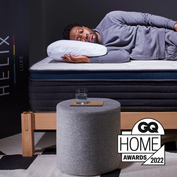 Man Sleeping on a Helix Midnight Luxe while using a Helix Wood Frame and Helix Pillow