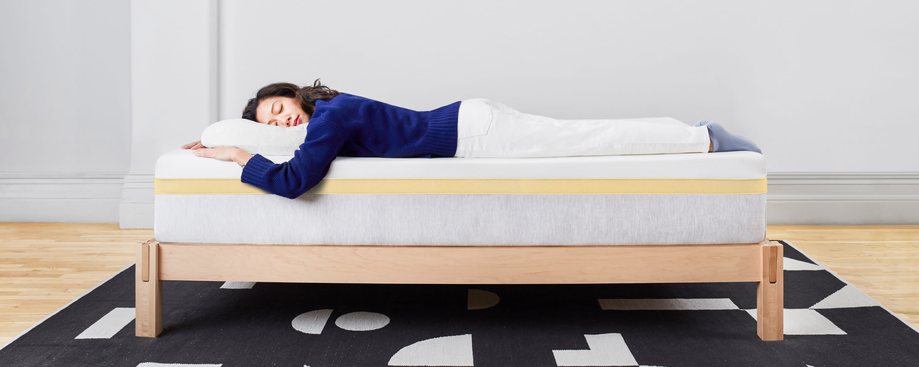 Woman sleeping stomach down on Helix Dawn mattress