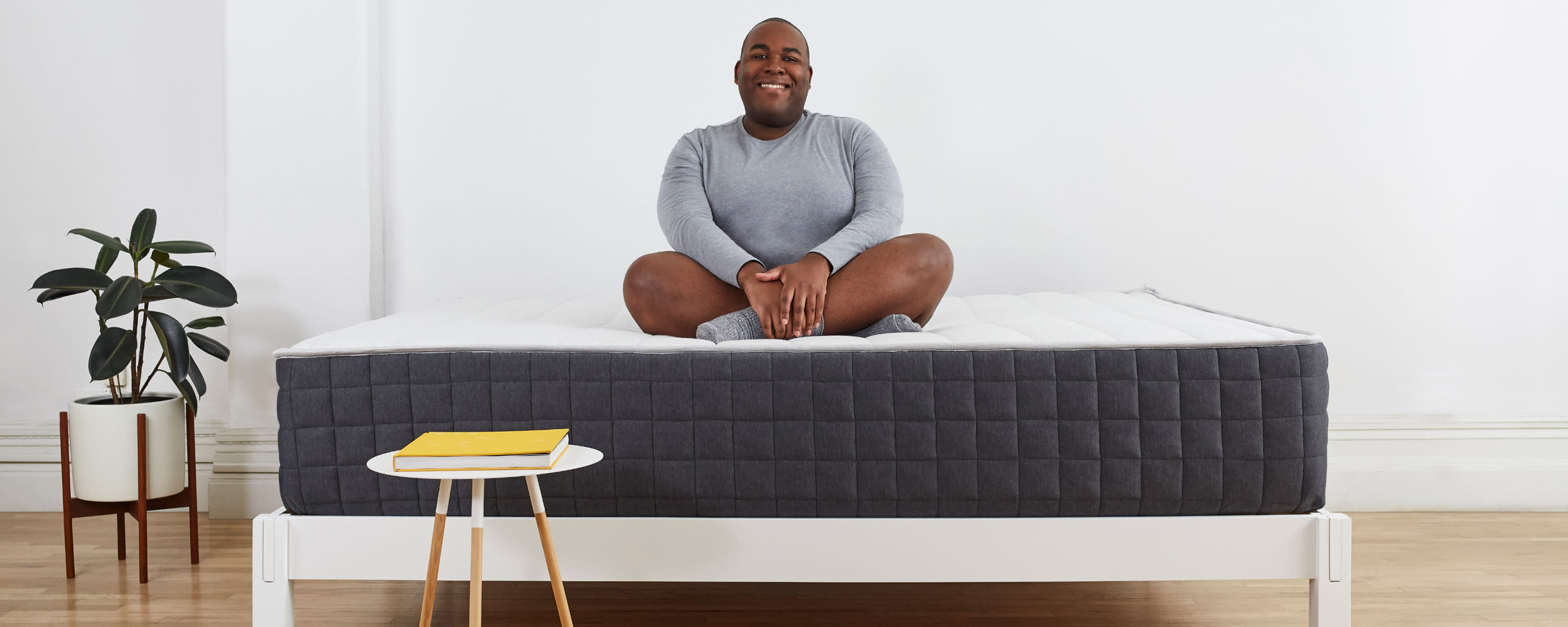 Person-sitting-on-Helix-Mattress