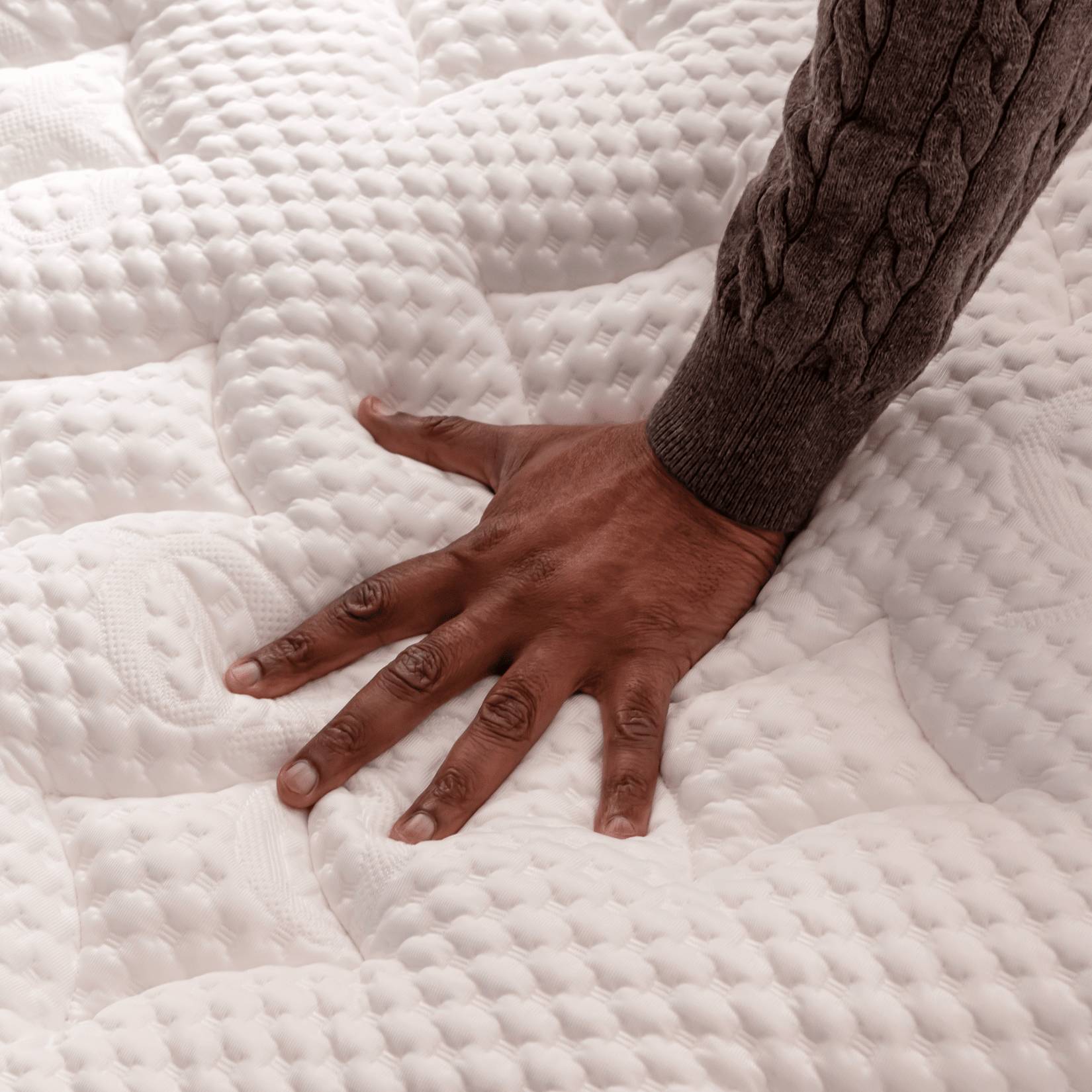 Hand pressing into Helix Elite Mattress