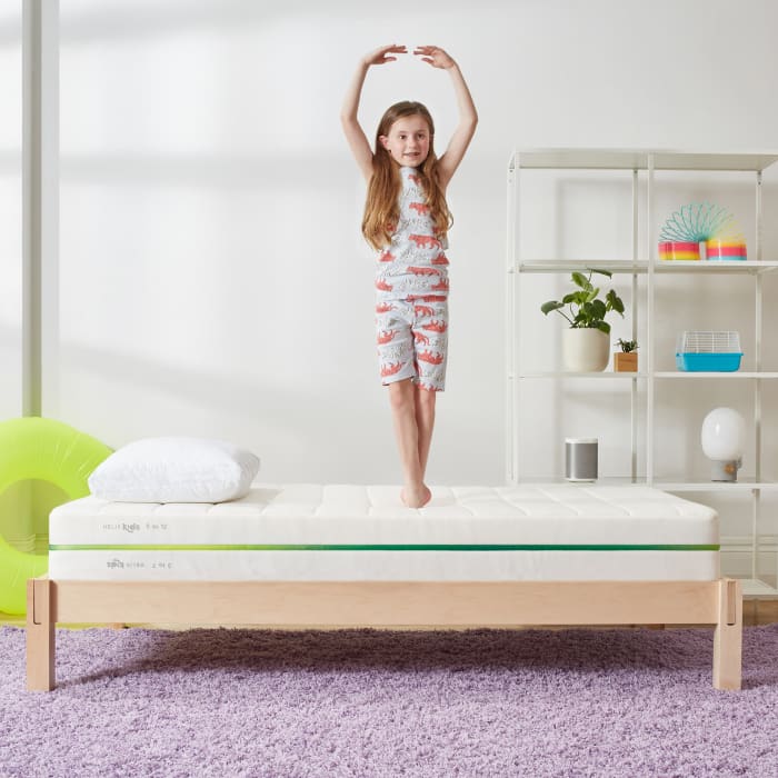 Child standing on Helix Kids Mattress