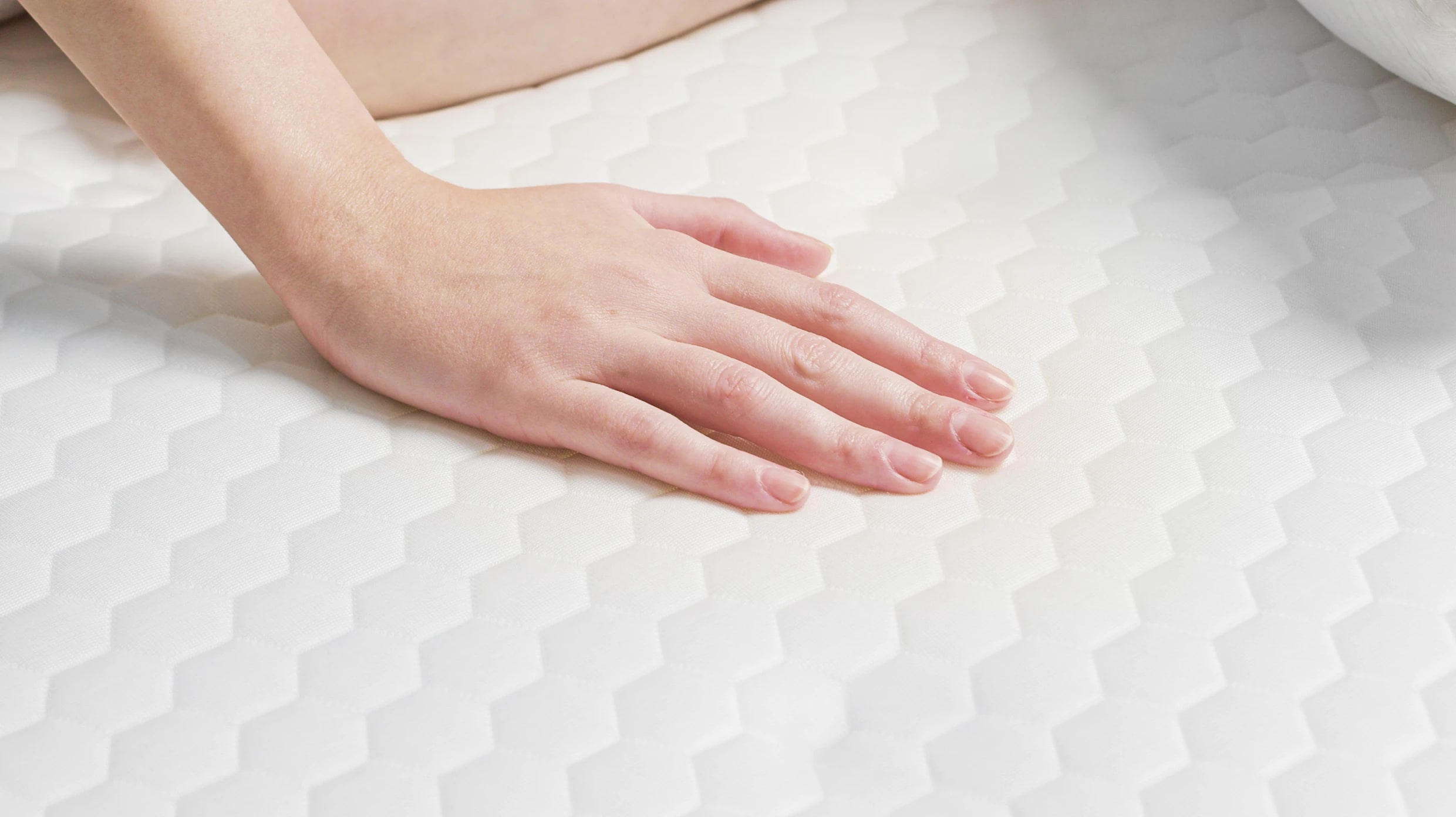 A lifestyle image showing a closeup of the Helix GlacioTex Cooling Mattress Protector
