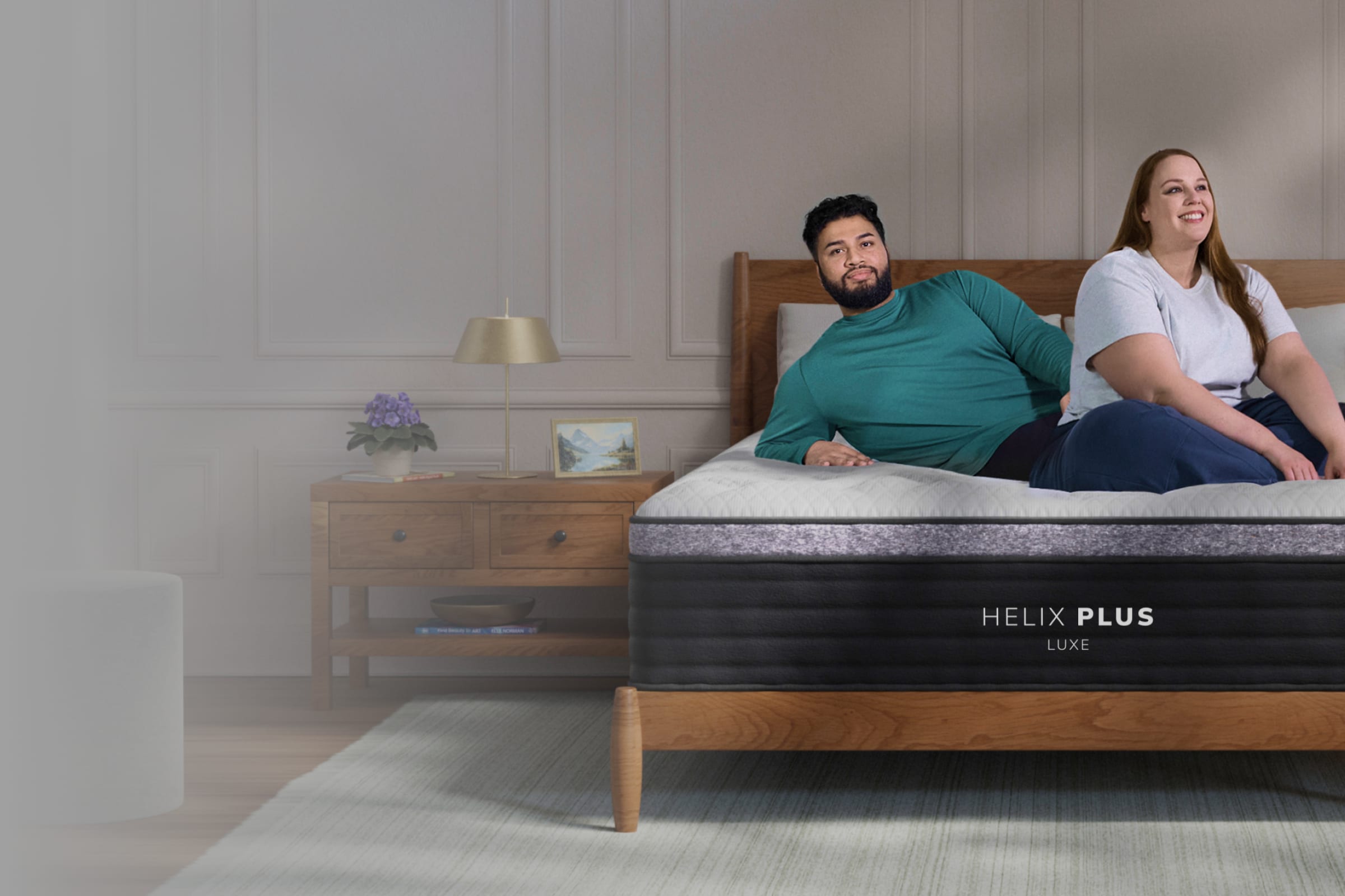 A lifestyle render showing models on the Helix Plus Luxe mattress