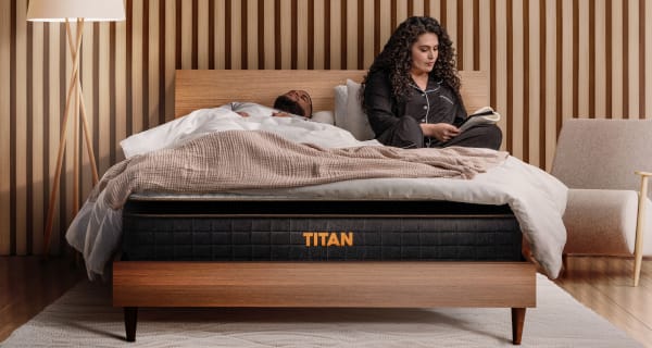 Young couple laying on a Titan Plus Elite in a luxury bedroom