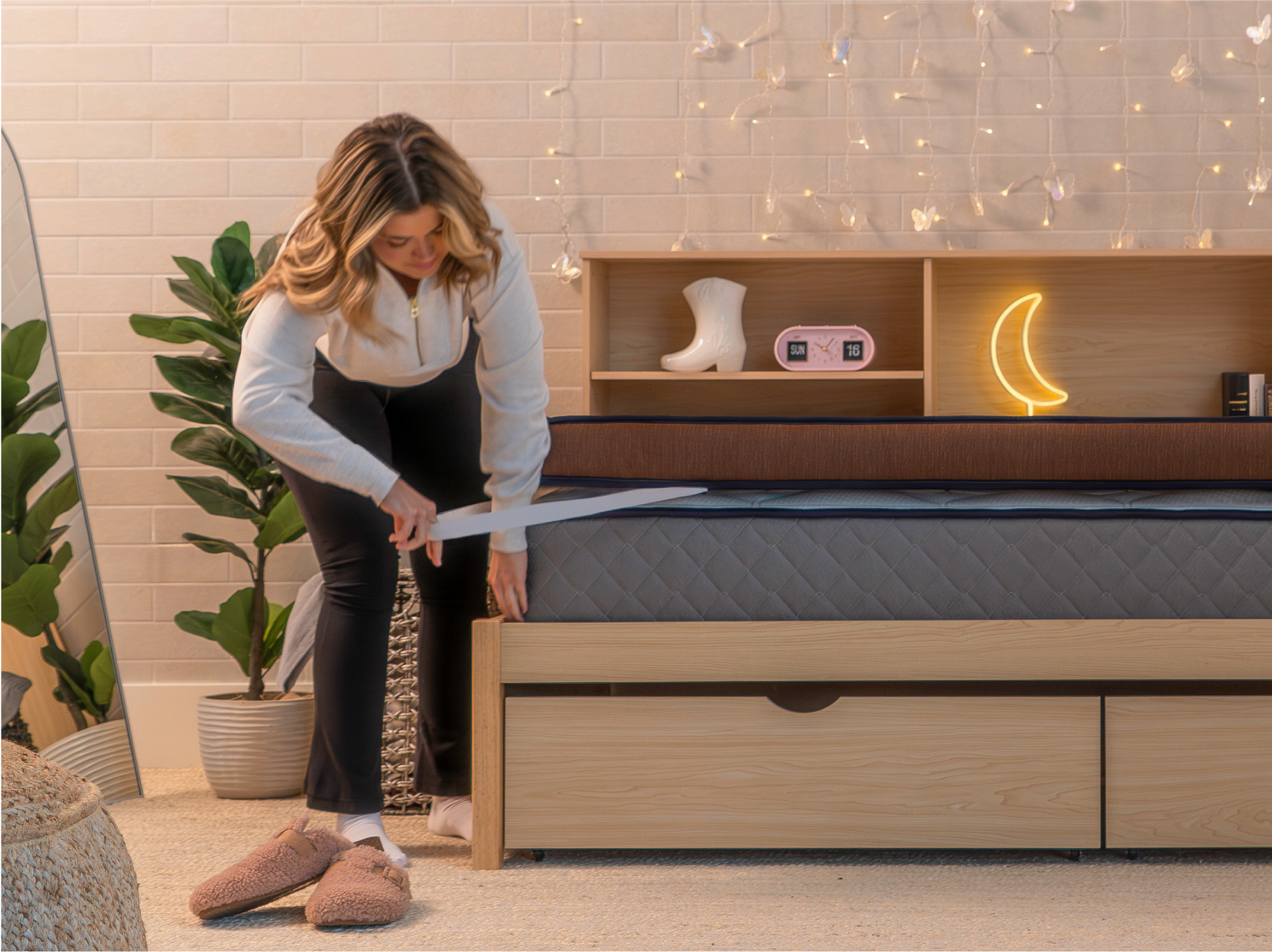 Young woman installing the Copperflex 401 Mattress Topper in a dorm