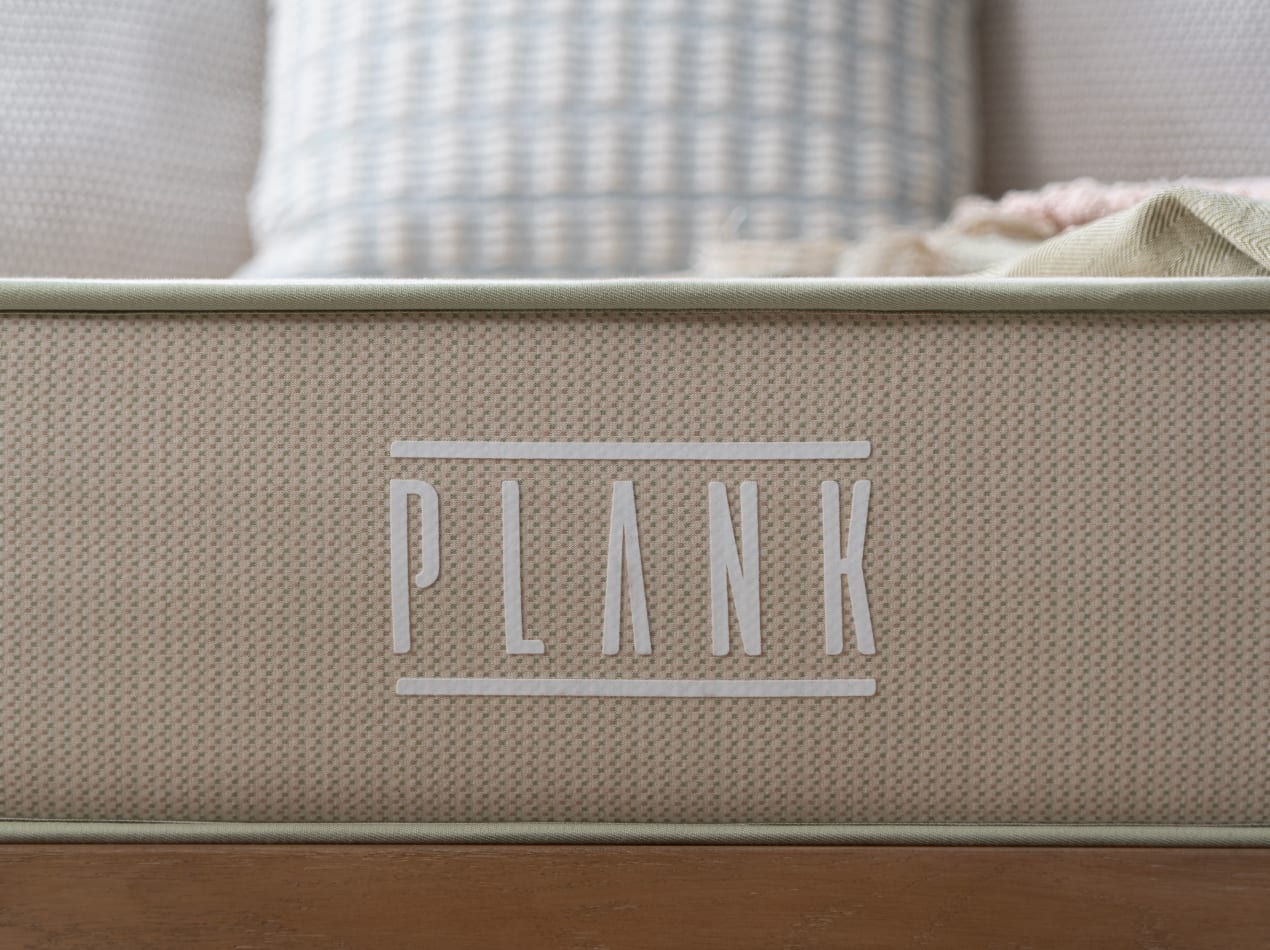 Plank Firm Natural close up on logo