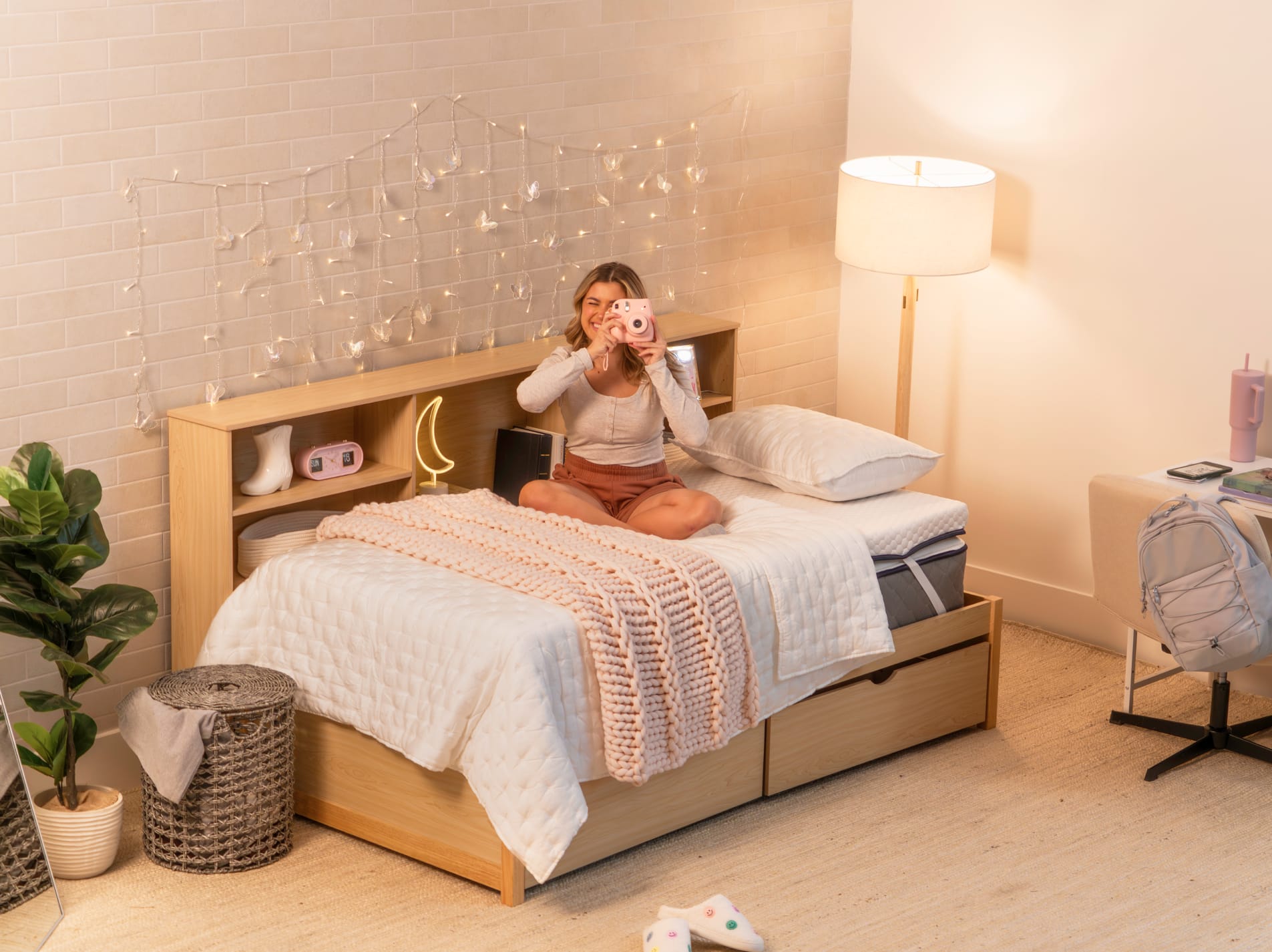 Young woman taking a picture sitting on the Copperflex 301 Mattress Topper