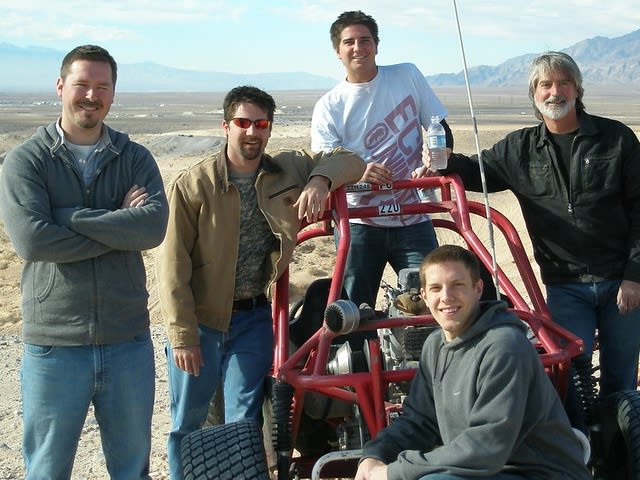 group of men next to a buggy in the desert| ©Hades Bane