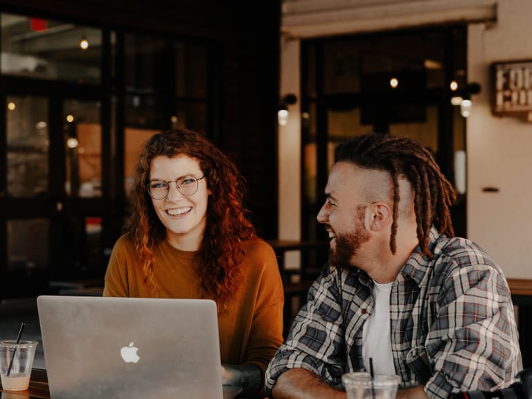 man and woman sitting in front of a laptop| © Brooke Cagle 