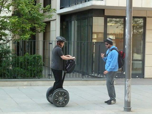 Woman on Segway and man walking| ©Tony