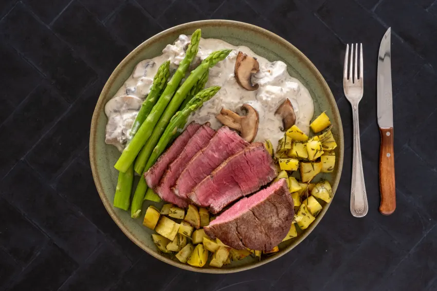 9 oz Fillet Steak in Creamy Mushroom Sauce with Rosemary Potatoes and Asparagus