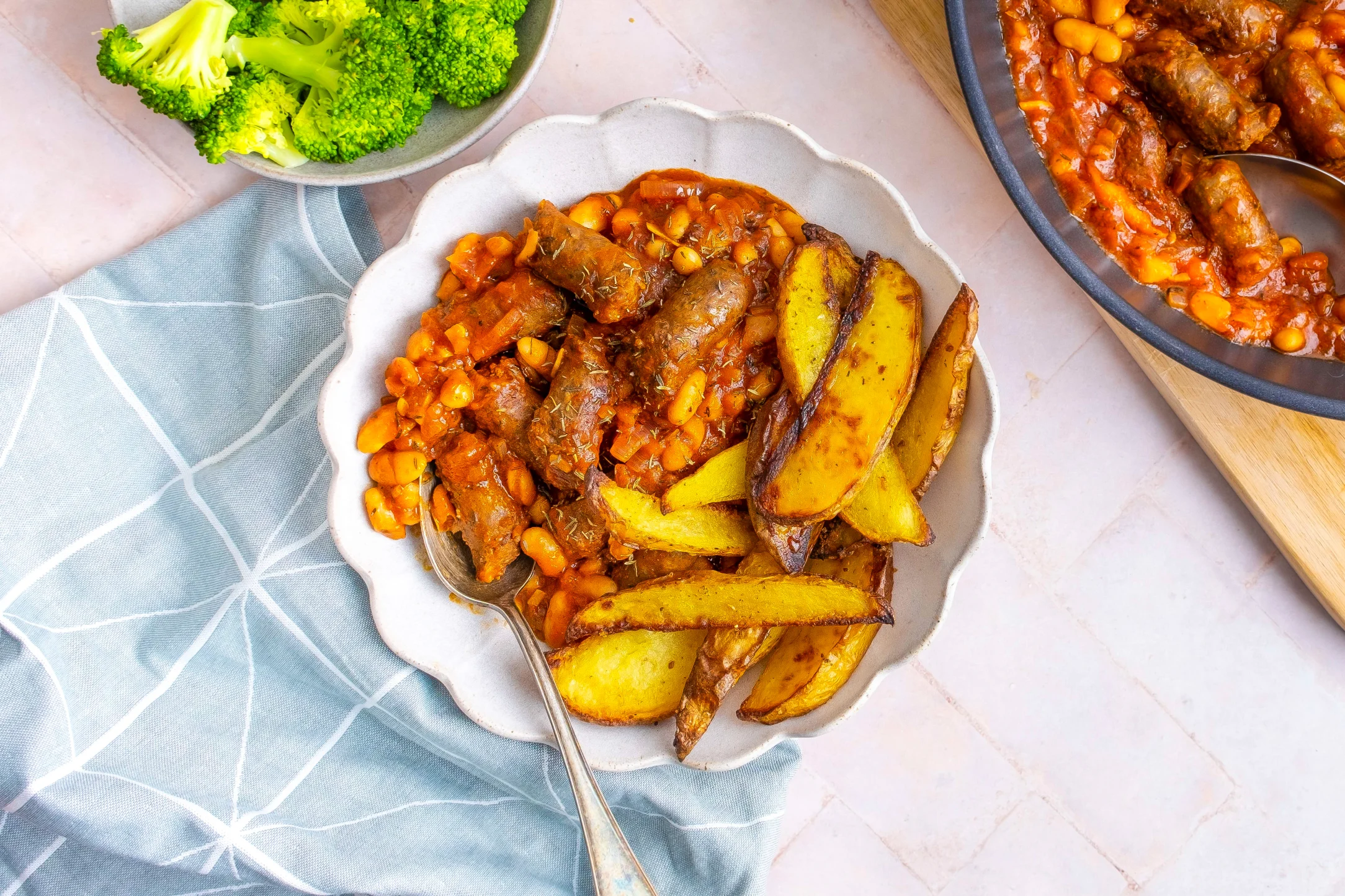 Beef Sausage and Bean Casserole with Potato Wedges and Broccoli