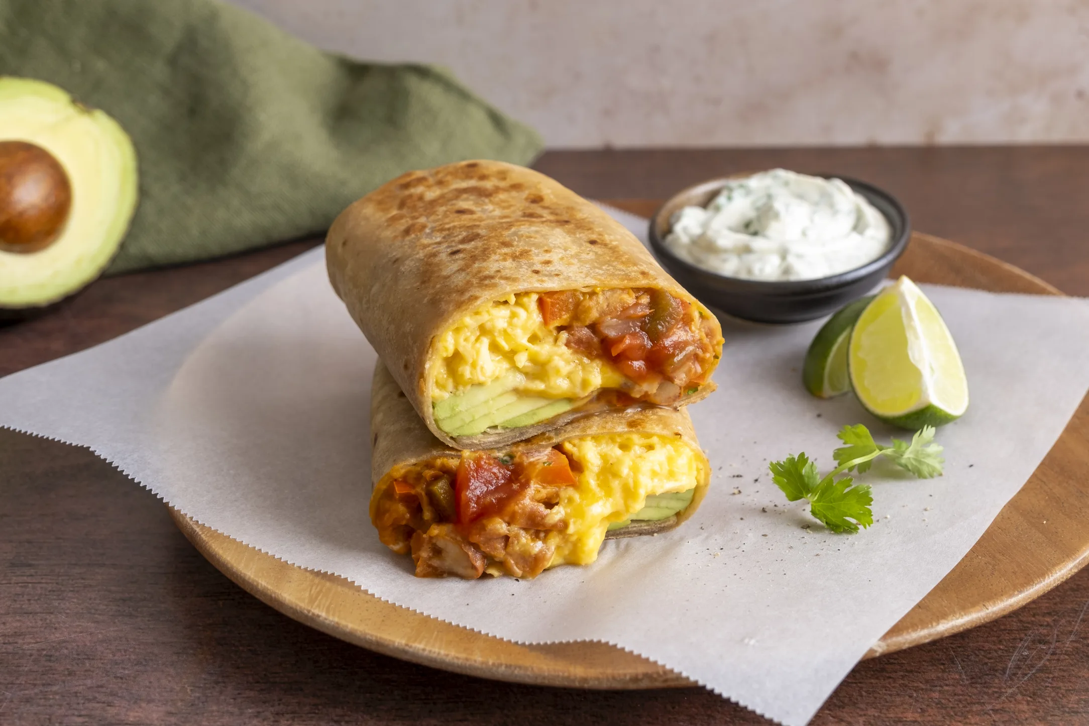 Breakfast Burrito with Cheesy Eggs, Fried Beans, Avocado and Coriander Crema