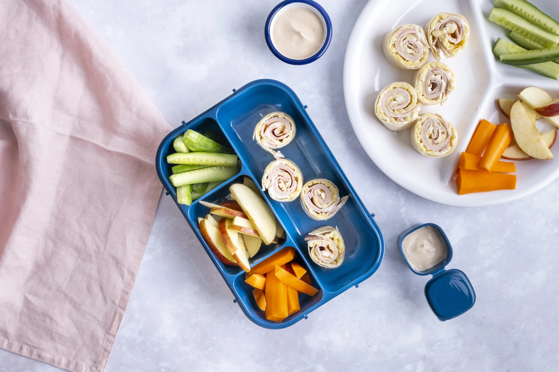 Turkey and Cheddar Tortilla Roll-Ups with Carrots, Cucumbers, Apples and BBQ Cream Cheese Dip