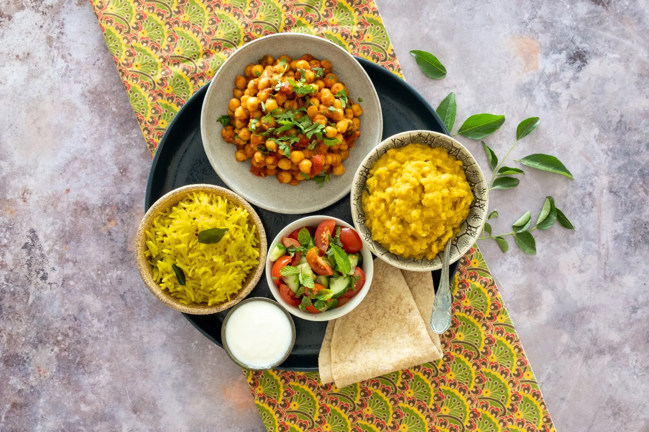 Indian Veg Thali Plate: Chickpea Masala and Black Pepper Dahl with Lime Rice, Mint Salad and Chapatis