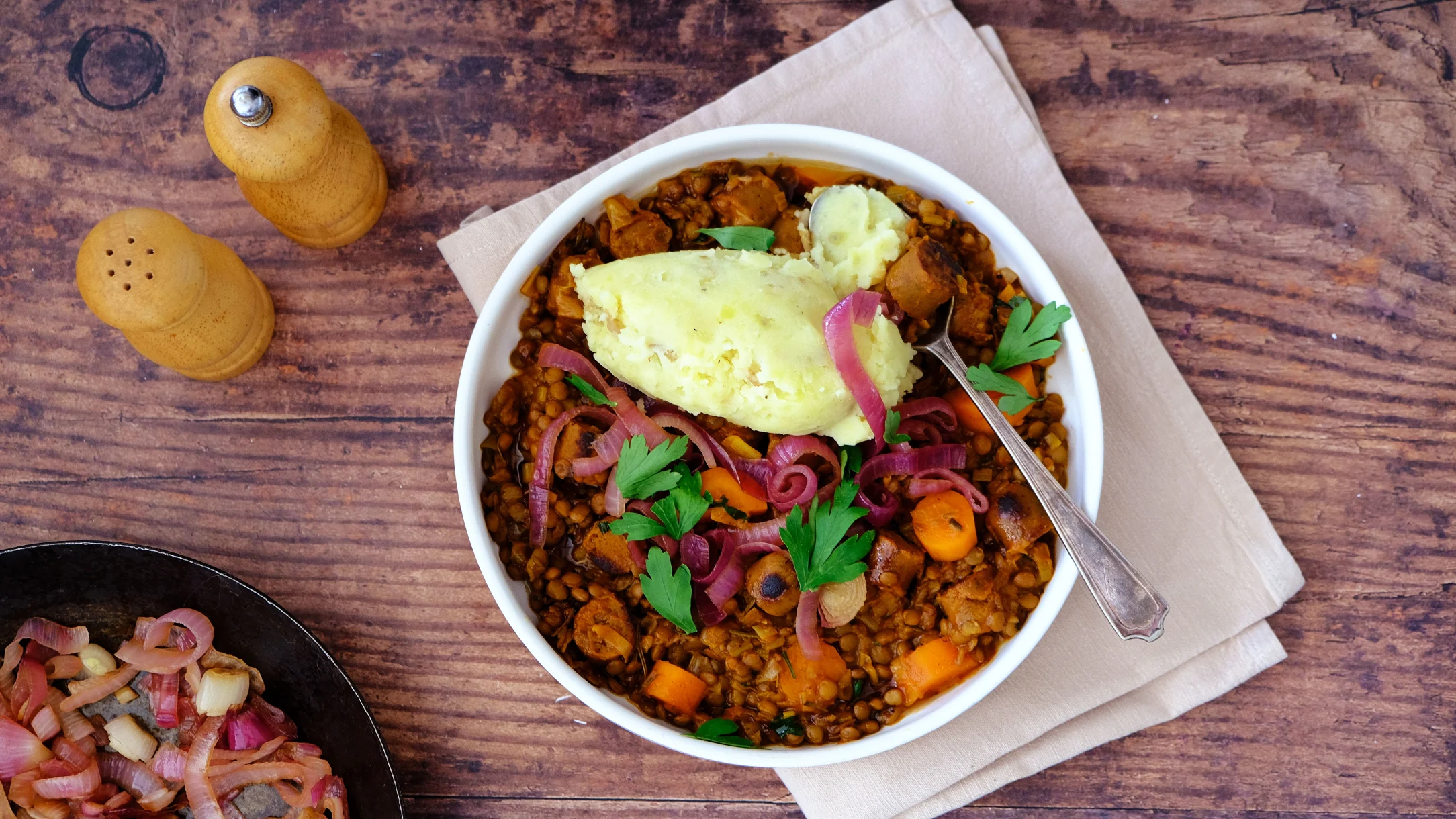Lentil and Vegan Sausage Casserole with Skin-on Mash and Caramelised Onions