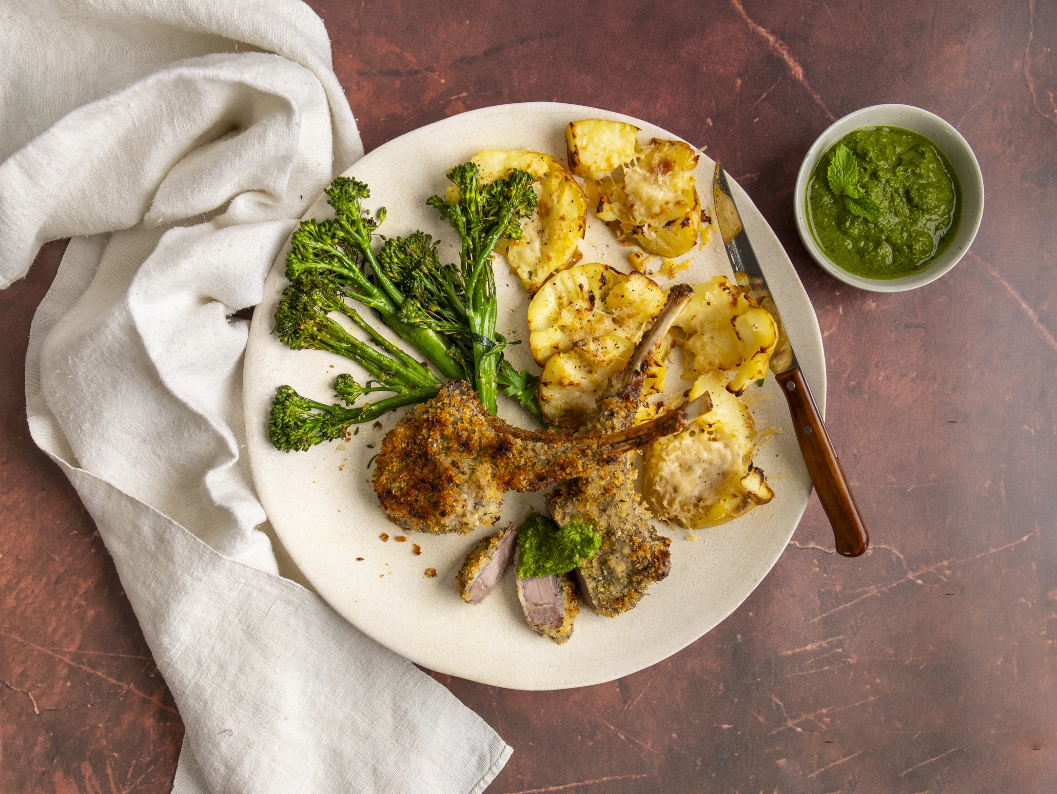 Herb Crusted Lamb Chops with Parmesan Smashed Potatoes, Roasted Broccoli and Mint Dressing