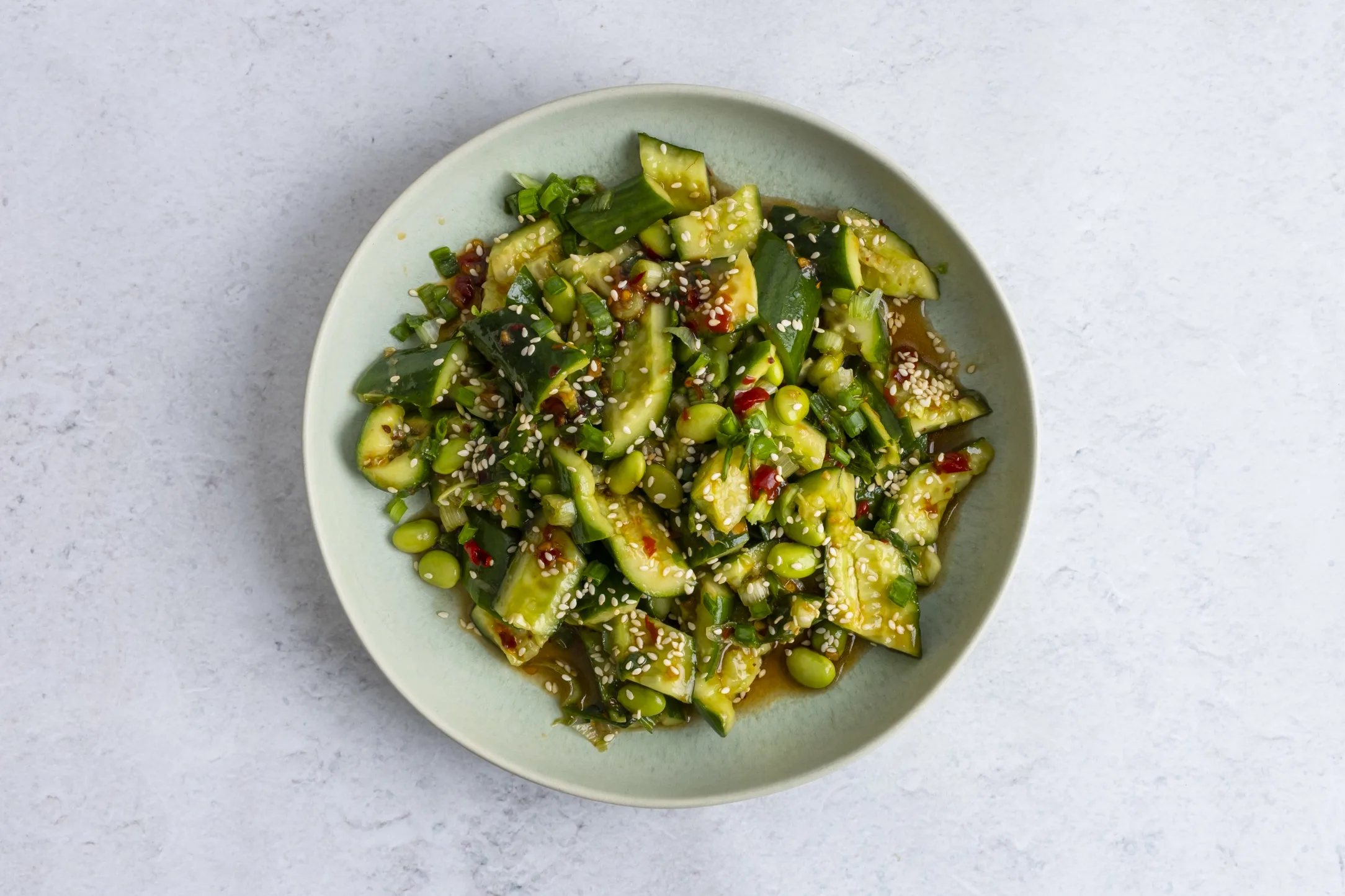 Smashed Cucumber and Edamame Salad with Chilli Garlic Dressing and Sesame Seeds