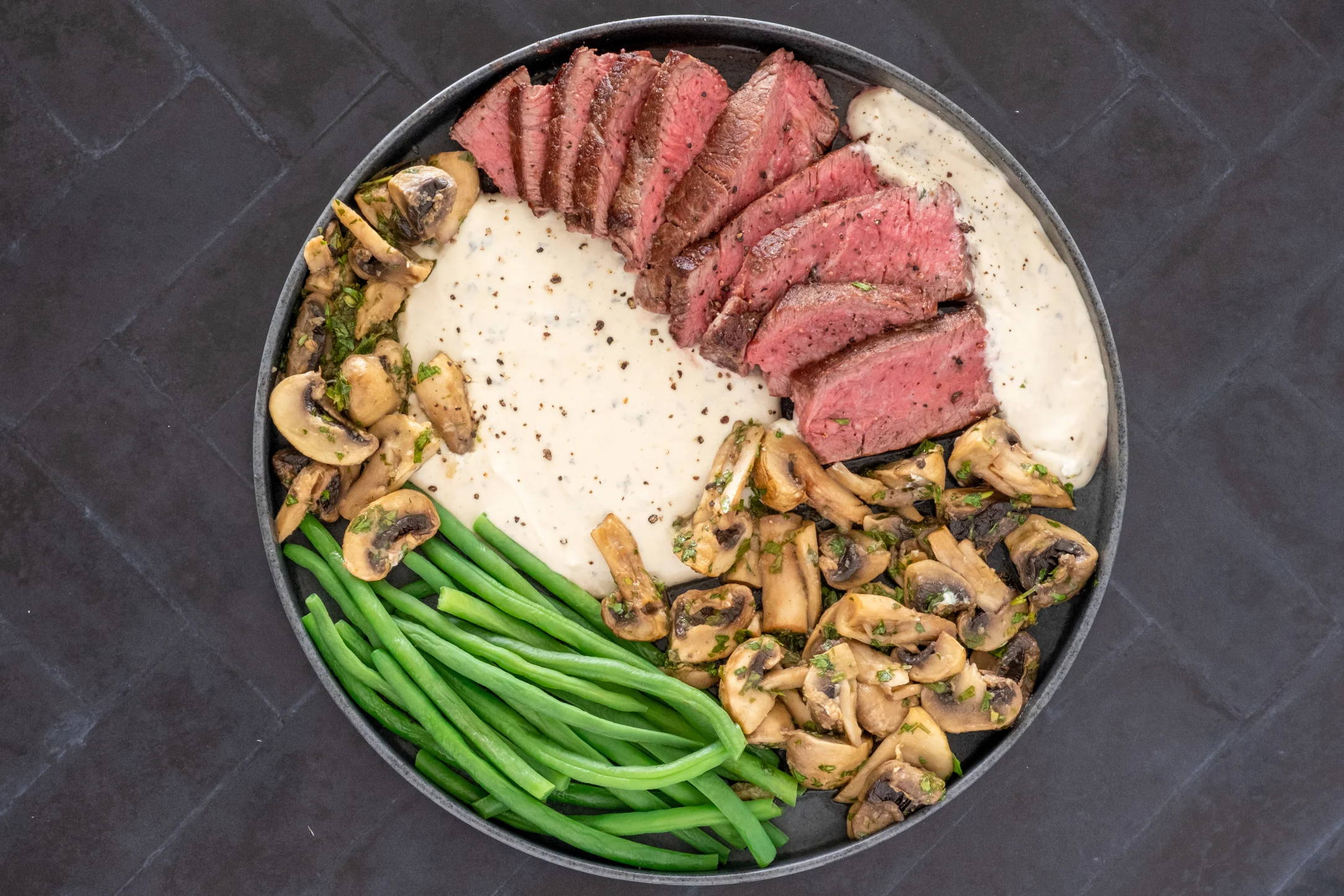 Tenderloin Fillet Steak in Blue Cheese Sauce with Garlic Mushrooms and Green Beans